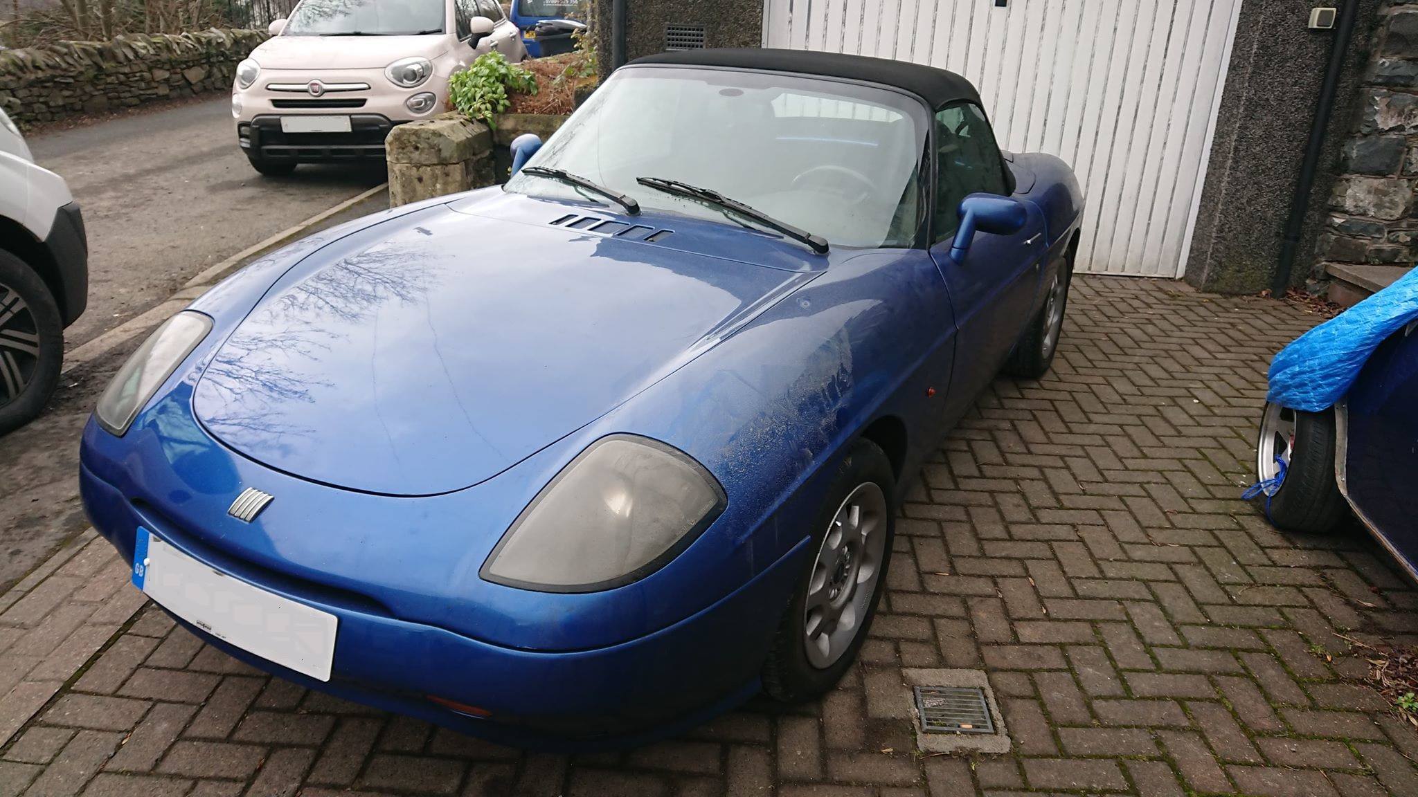 Blue Fiat Barchetta with black hood