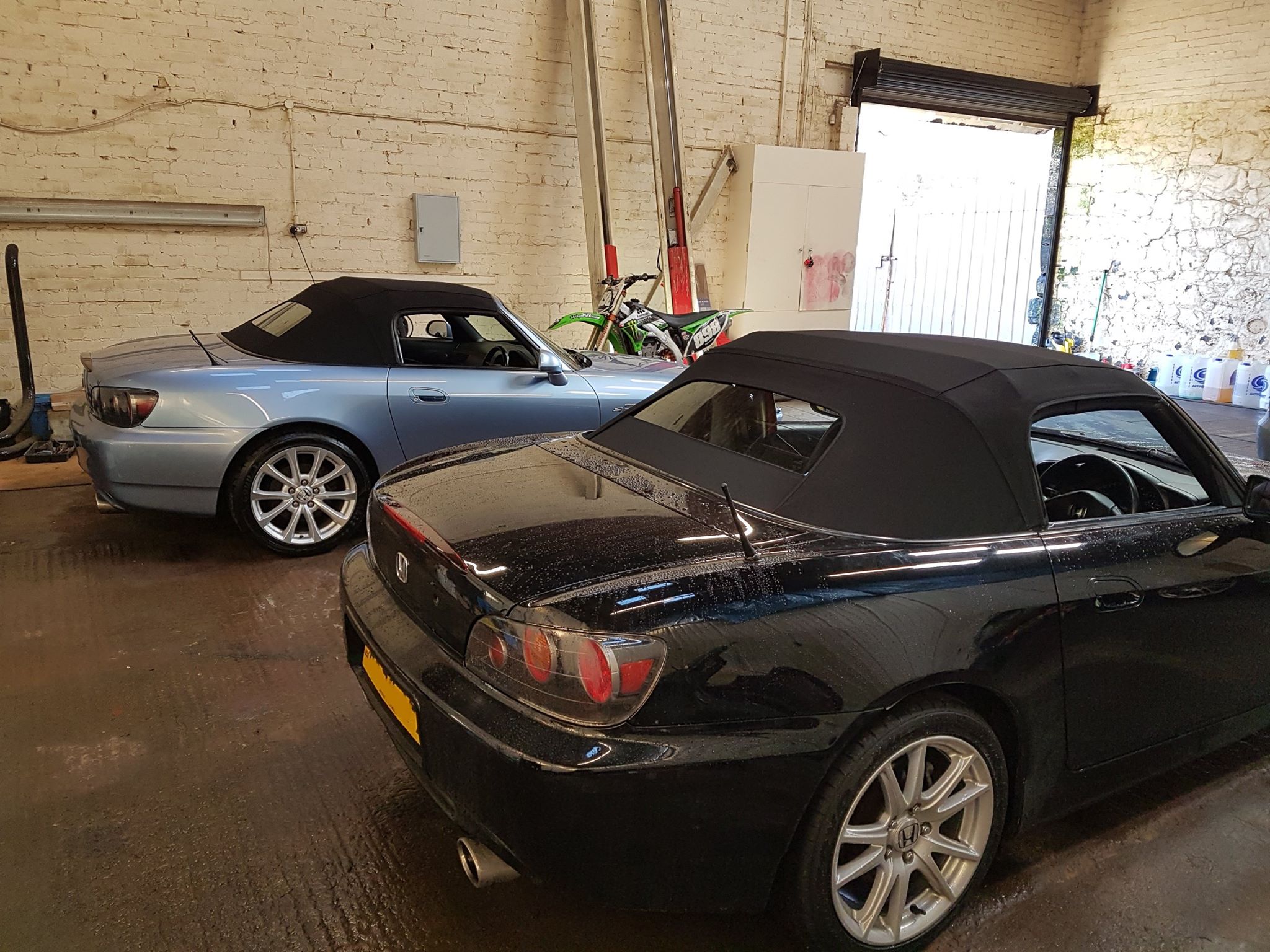 Two Honda S2000s in the workshop from the rear